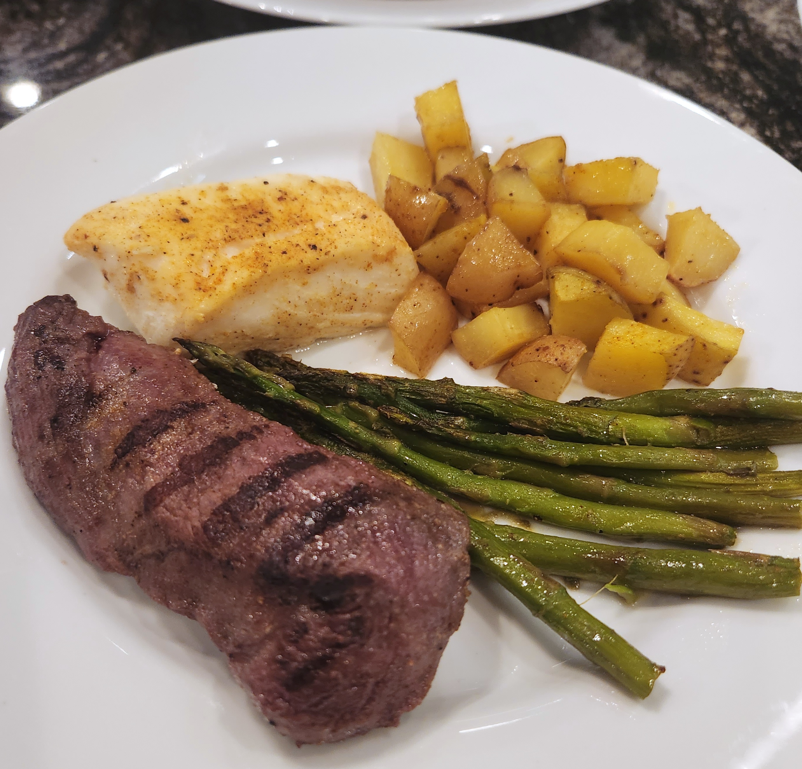 Ostrich and Halibut Surf and Turf with Roasted Garlic Potatoes and Asparagus